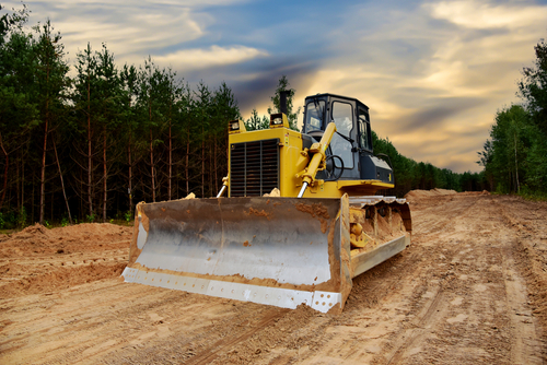Dozer,during,clearing,forest,for,construction,new,road.,bulldozer,at