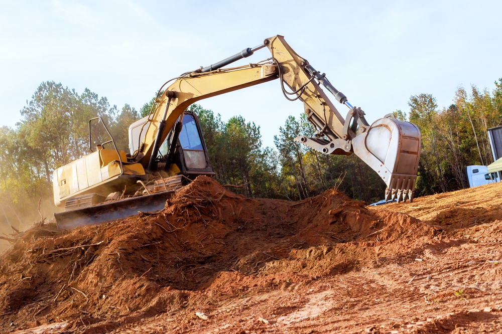 Large,excavator,works,diligently,,moving,earth,,debris,at,during,construction